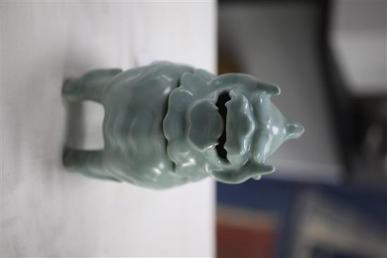 A Chinese celadon-glazed lion-dog censer and cover, 18th century, 17.2cm, wood stand